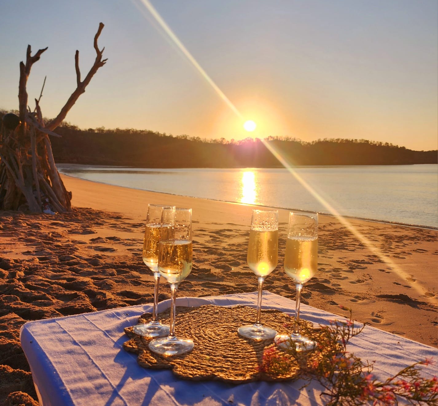 Beach bonfire and drinks at sunset